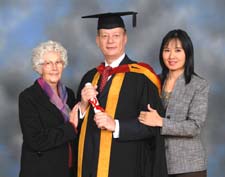 Victor with his mother and his partner receiving his LLM