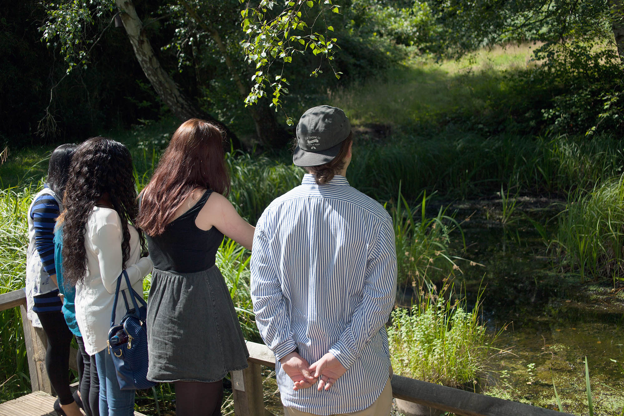 Students by the pond on Kingston Hill campus