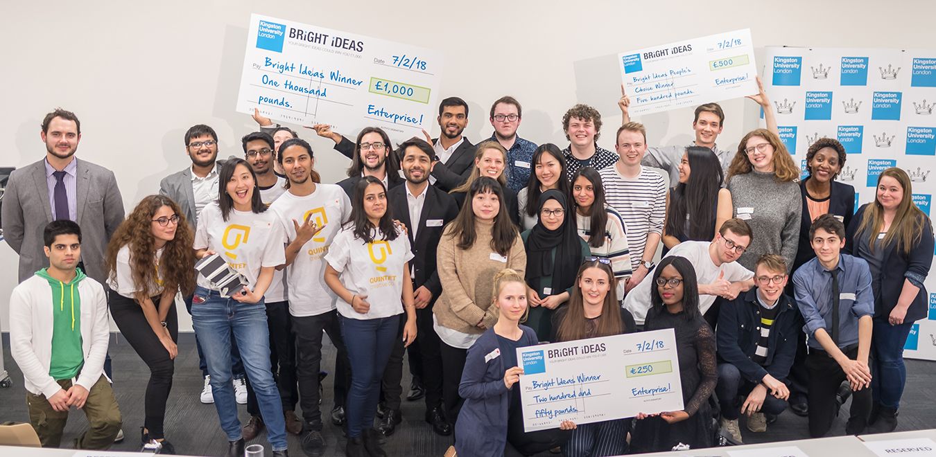 prize winning students stand together with cheques