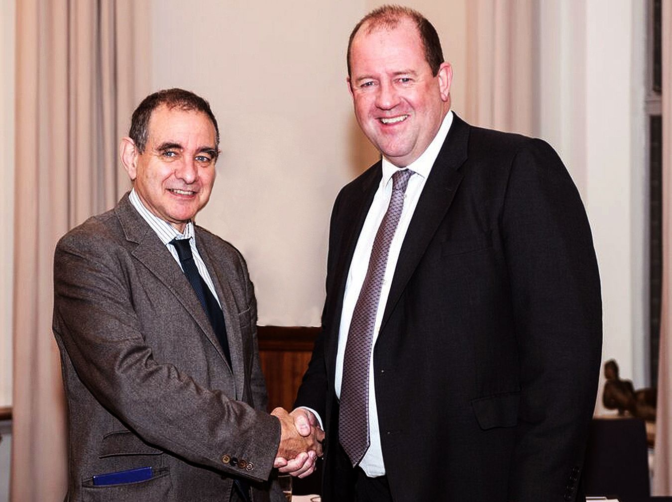 Kingston University Vice-Chancellor Professor Julius Weinberg shaking hands with Amey Plc Chief Executive Mell Ewell.