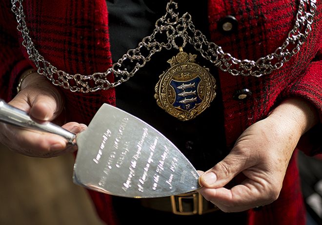 Photo of mayor holding silver trowel.