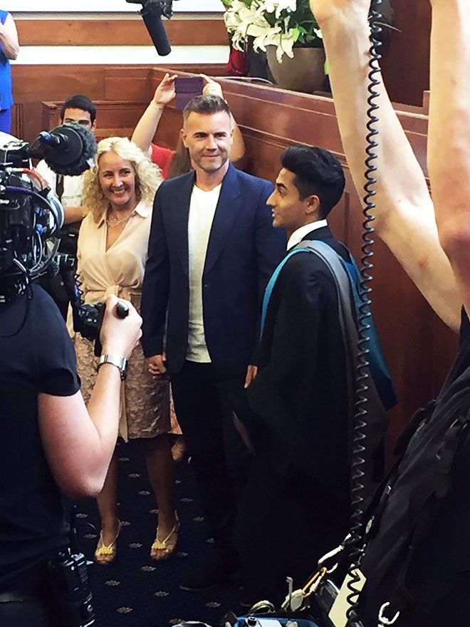 Photo of Kingston University graduate Anthony Sahota with his mum and Gary Barlow at his graduation surprise.