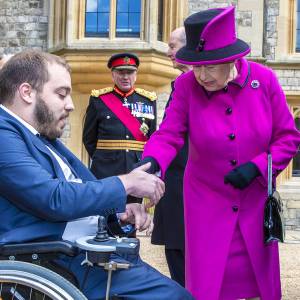 Queen presents adapted Motability vehicle to Kingston University disability adviser at Windsor Castle