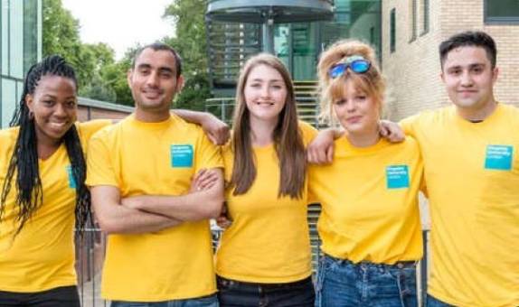 Student ambassadors in yellow t-shirts smiling