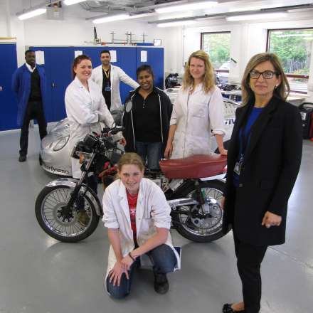 Students and staff with vehicles in the automotive lab