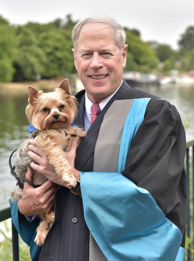 Metro Bank founder Vernon Hill - accompanied by Yorkshire terrier Duffy - was named an Honorary Doctor of Letters during Friday\'s first graduation ceremony.