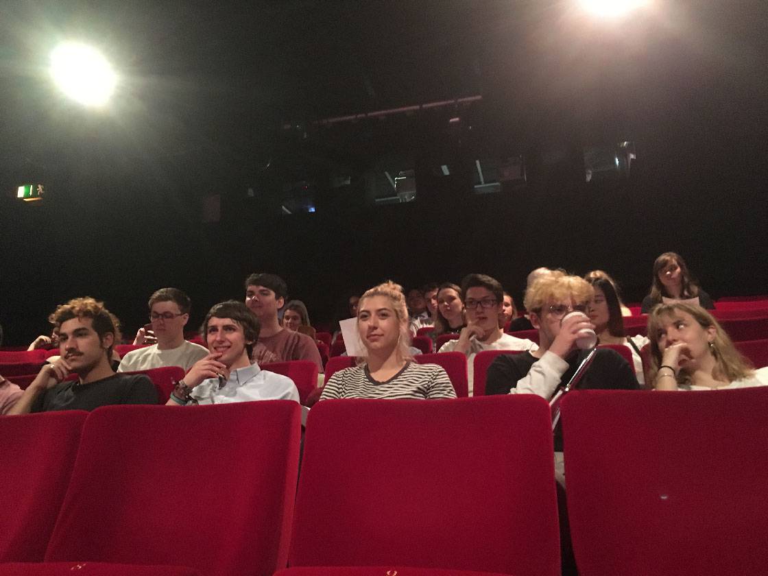 A group of people sitting in a cinema.