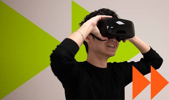 A male student wearing a virtual reality headset