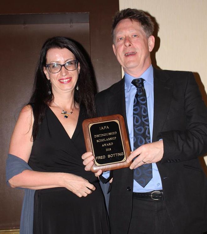 Professor Fred Botting accepts his Distinguised Scholar Award from IAFA president Professor Sherryl Vint 