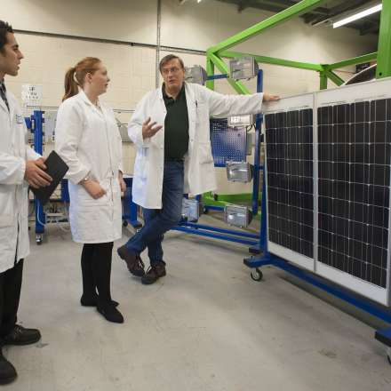 Students look at solar voltaic panels