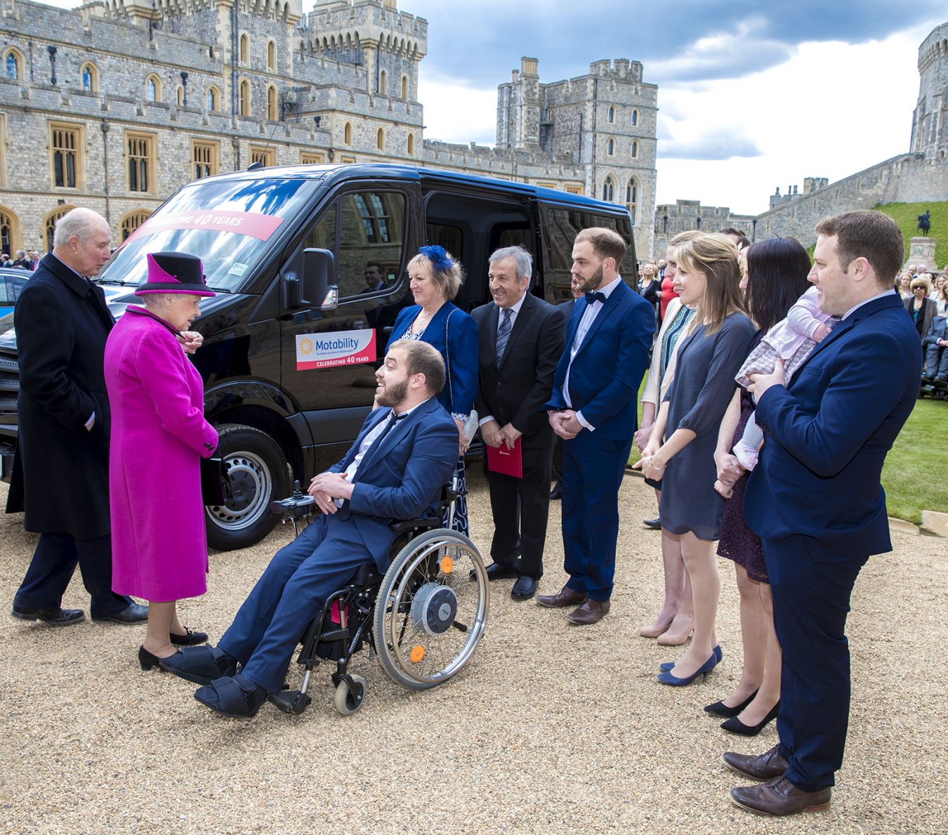 An image of the Queen speaking to Kingston University staff member Edward Todino and his family