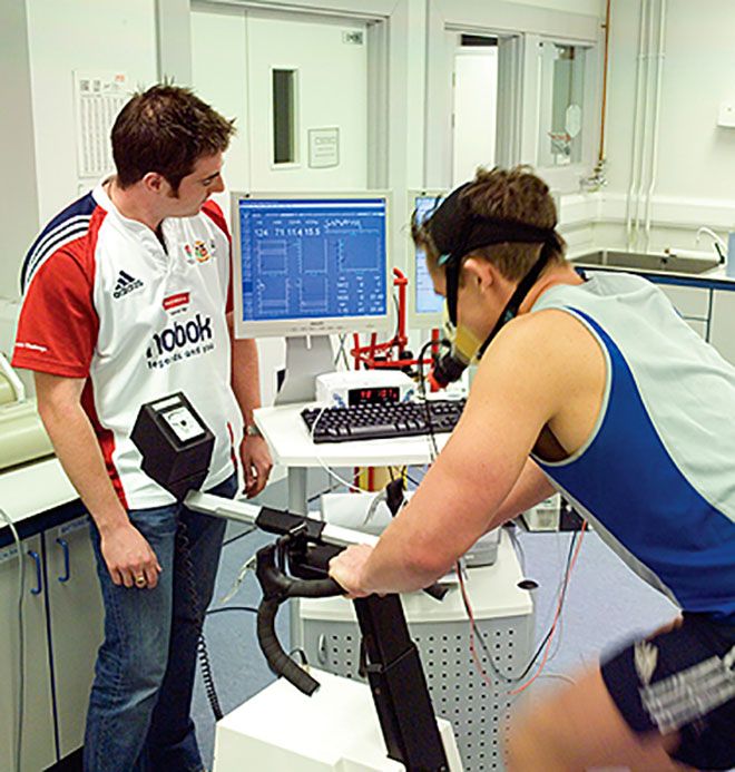 A photo of two people in a sport science lab.