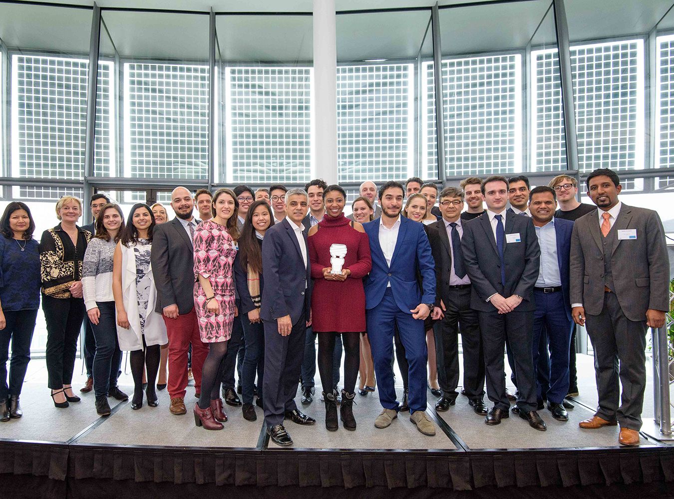 Mayor\\\'s Entrepreneur contestants stand in a group with Sadiq Khan and winner stands in the middle holding trophy