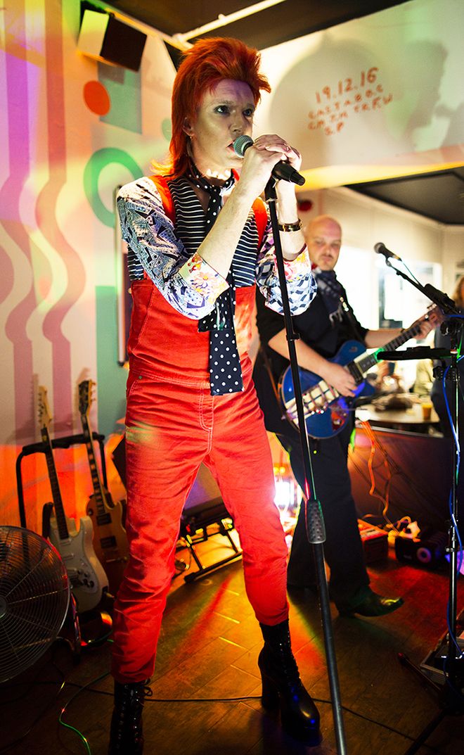 Photograph of Professor Will Brooker dressed as Ziggy Stardust singing at the David Bowie celebration gig