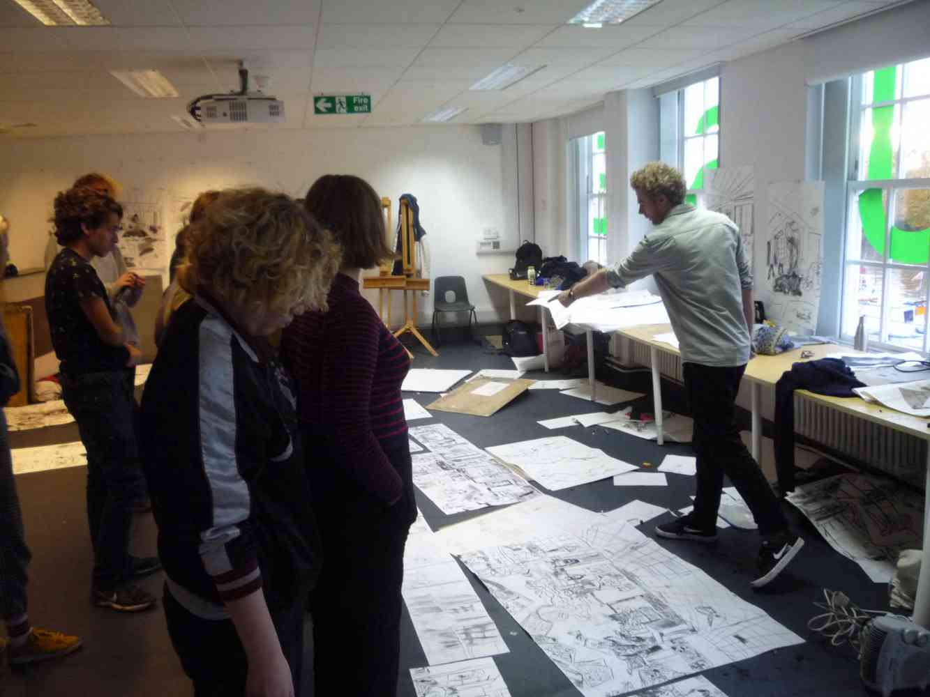Josh Armitage leading a scale drawing class - Josh Armitage giving end of session reviews to works made by students