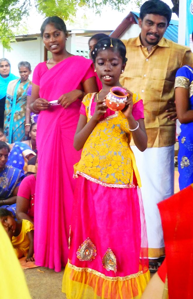 Picture of a young girl showing a put she\'s made in India.