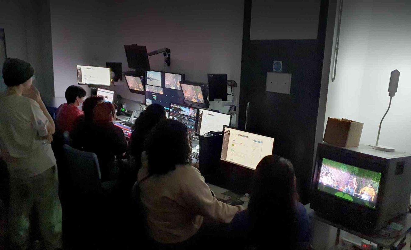 Students working at computers in the TV studio facilities