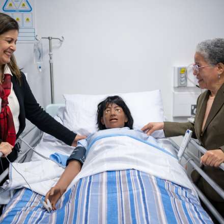 Dame Elizabeth Anionwu (right) being shown one of the patient simulator mannequins by Head of the Pharmacy Department at Kingston University, Professor Reem Kayyali (left) 