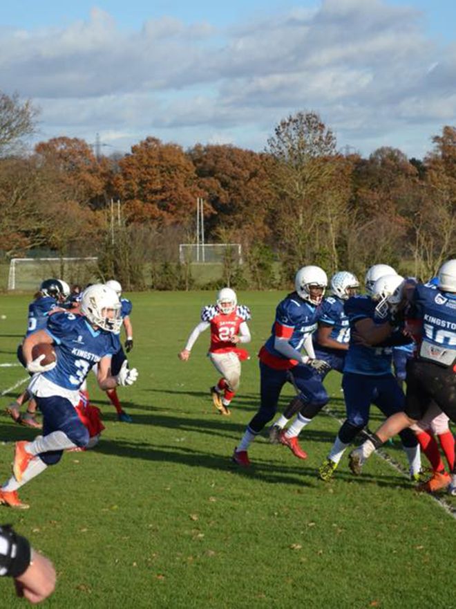 American football players scrummage for the ball