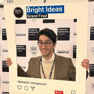 Photo of Atabak Iranizad, posing inside a frame that reads: Bright Ideas Grand Final