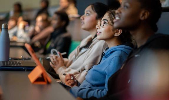 three students in a lecture