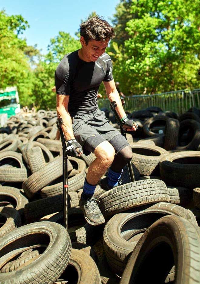 Picture of Oliver Lam-Watson on crutches taking part in an obstacle course