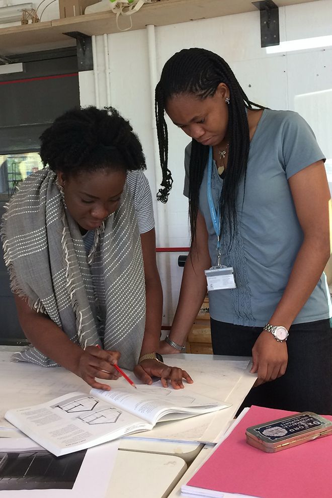 a tutor helps her students by showing her a diagram in a textbook