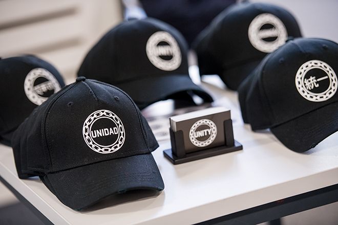 black hats lined up on a white desk