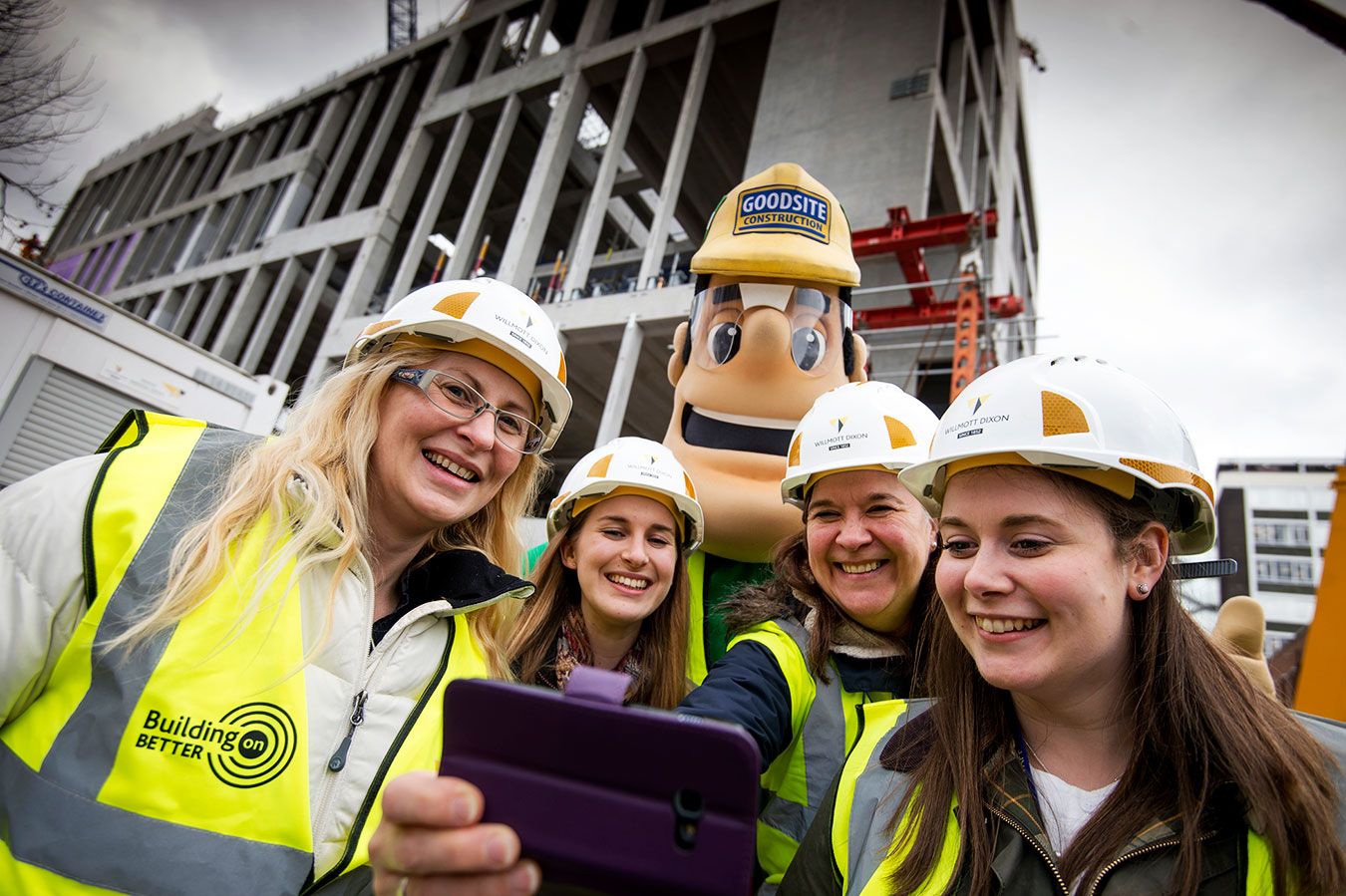 A photo of a group of people and construction industry mascot Ivor Goodsite in front of Town House