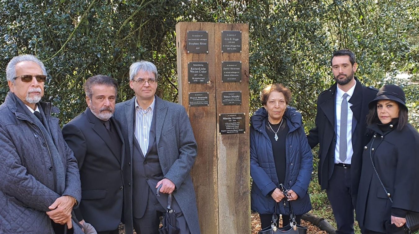 Ardeshir Tahmasebi (Saeed\'s father), Masood Ebrahim (Niloufar\'s father), Associate Dean of Education Dr Steve Bastow, Shahin Shakooea (Niloufar\'s mother), Faculty support manager Philip Lindsay and Sara Rastgou (Saeed\'s mother) by the plaque for Niloufar in the Kingston University memorial garden.