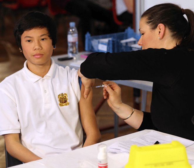 Teenage boy being given vaccination