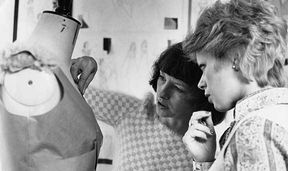 Black and white photo of students working with a manikin