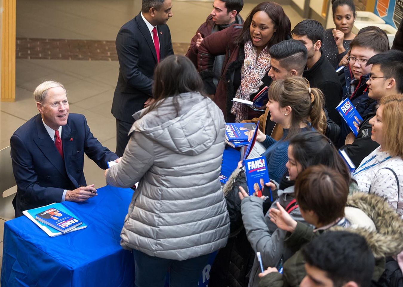 A photo of Vernon Hill signing books at Strategy into Practice seminar.