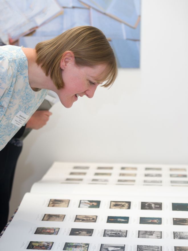 Civic reception visitor examines archive images