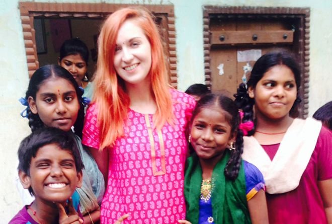 Kingston University journalism graduate Roxii Hoare-Smith surrounded by some of the children she met volunteering in India through the Lebara Foundation project.