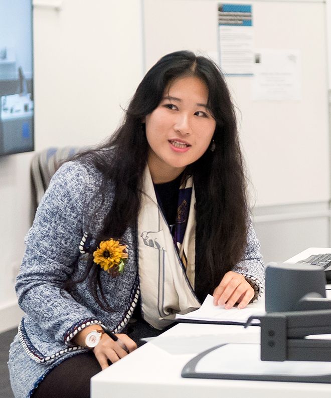 A photograph of business management student Sunny Ye at the hackathon event.