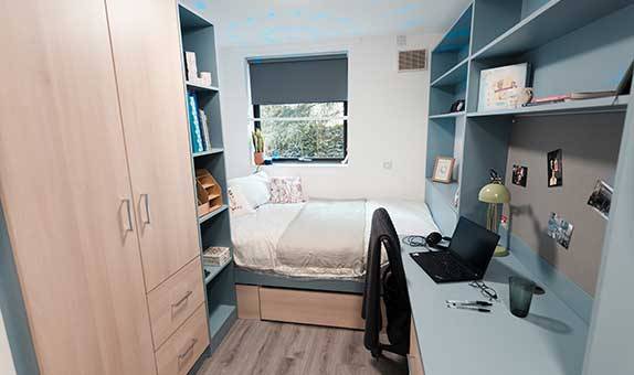 The affordable en suite room in Chancellors Hall showing the bed, desk and wardrobe 