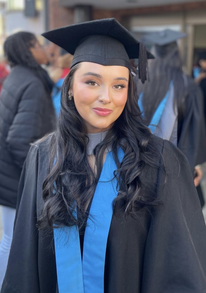 Graduate wearing gown and hat