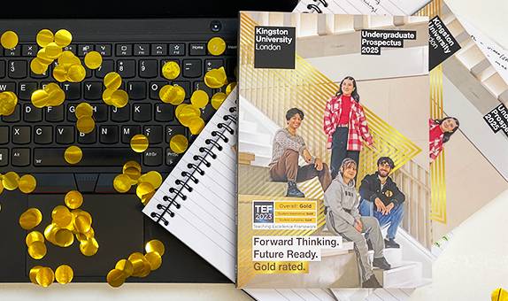 An image of the Undergraduate 2025 prospectus on a laptop keyboard, with gold confetti around it 