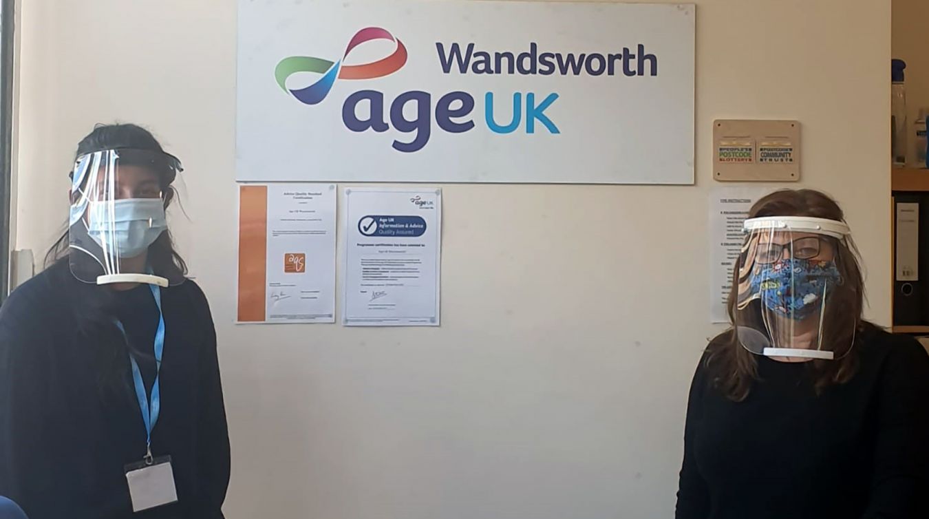 Staff at Age UK Wandsworth wearing the protective face shields donated by Kingston University.