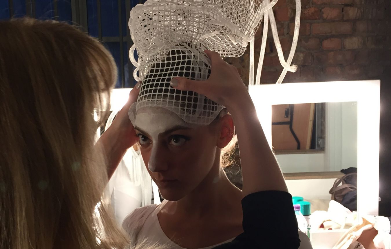 One of the dancers wearing Nigel Guérin-Garnett\'s designs prepares for the performance at Kingston University\'s MA Fashion show