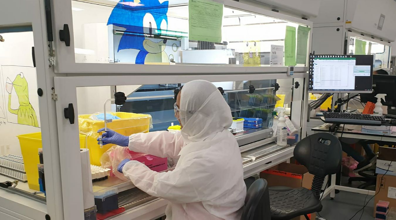 Amtul working on one of the Tecan machines in the Milton Keynes lighthouse lab.