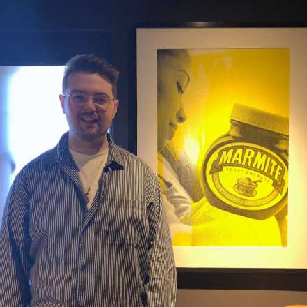 Kingston University graduate Brandon Coyle  with his Marmite inspired artwork.