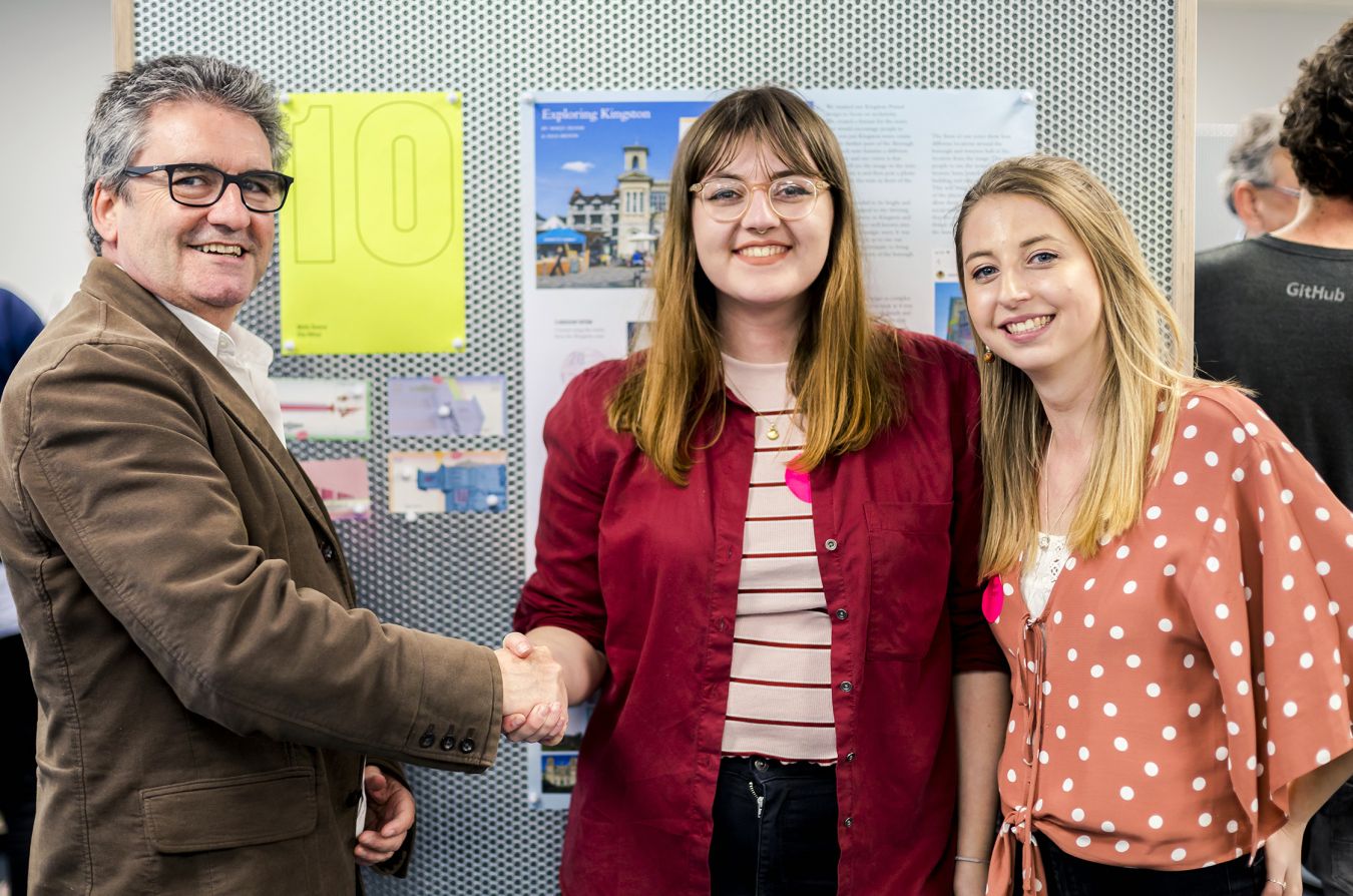 Co-founder of the Kingston Pound, Andrew Connolly, congratulates winning designers Molly Dunne and Ella Hilton.  