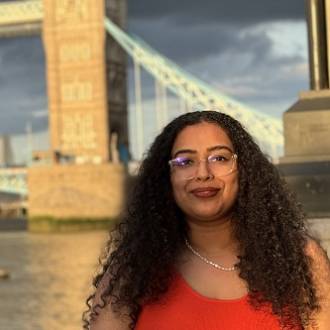 Smiling student standing near Tower Bridge, London