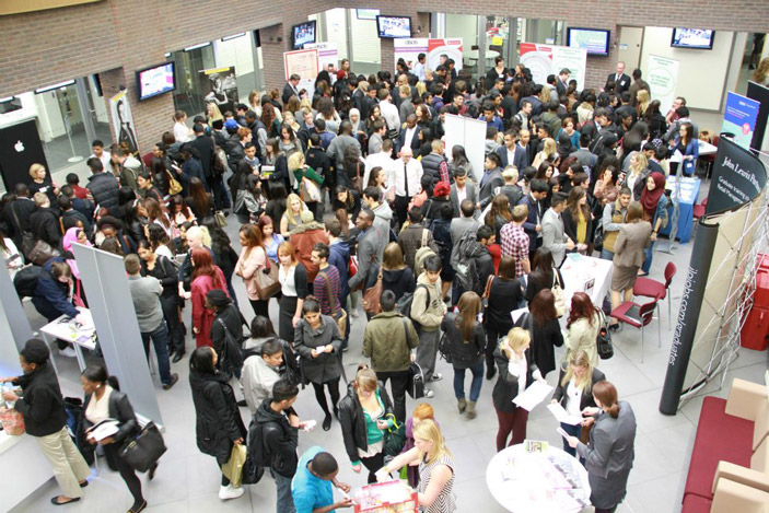 Careers event with retail employers in atrium of new Business School