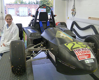 Sabine Brosch with the car created by members of Kingston University's e-racing team.