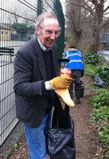 Community volunteer Richard Ivor James holding the plastic foot found in the river.