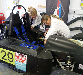 Student Sabine Brosch, left, and lecturer Gordana Collier make adjustments to the electric racing car in the laboratories at the Roehampton Vale campus.