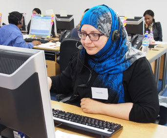 Biomedical science student Farhat Bibi answers inquiries from Clearing hotline callers.